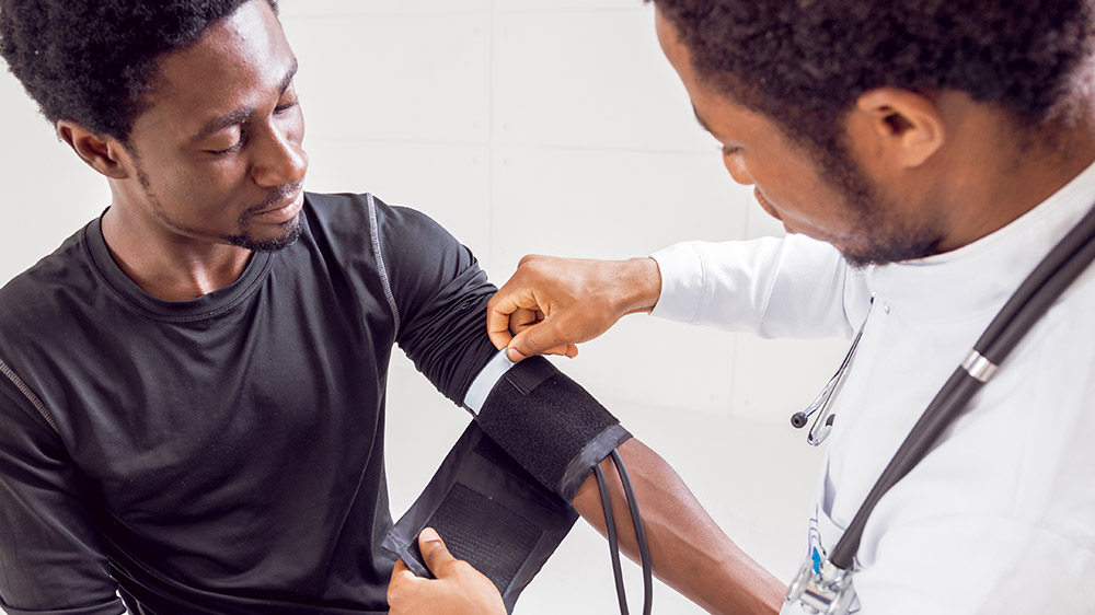 doctor checking blood pressure of man