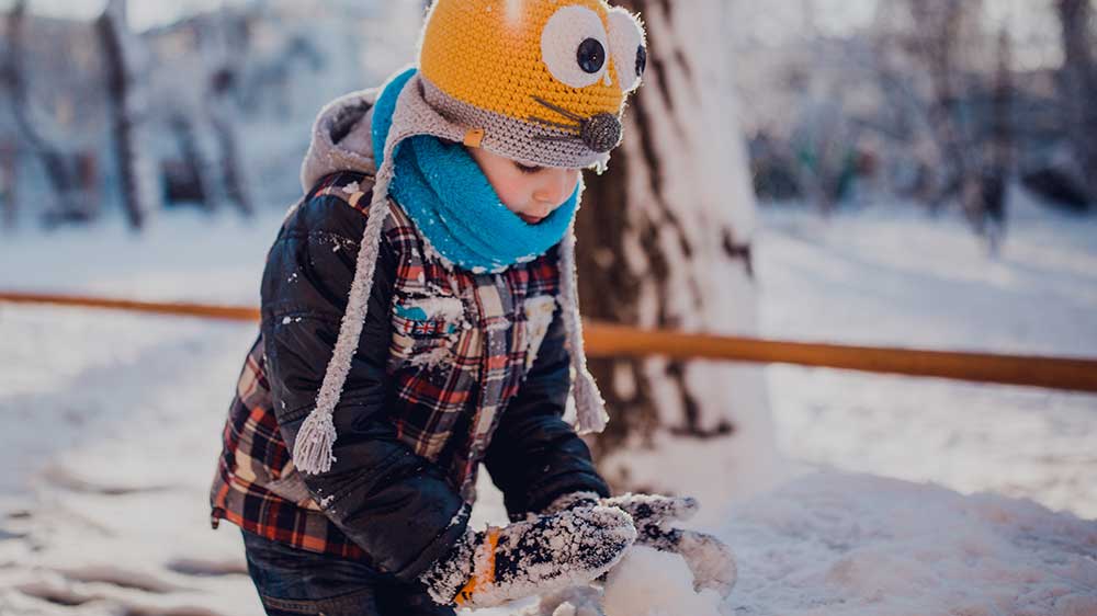 Kid building a snow man